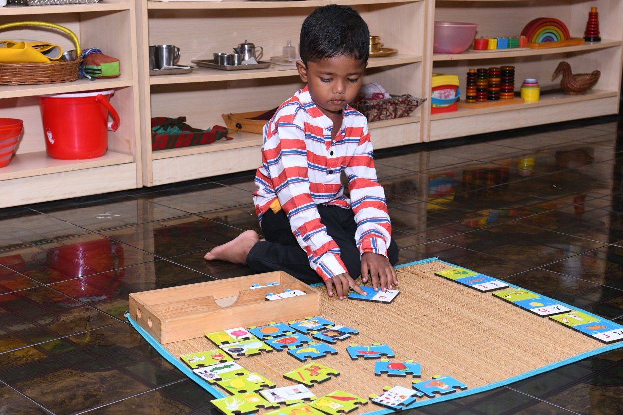 A child exploring Montessori materials